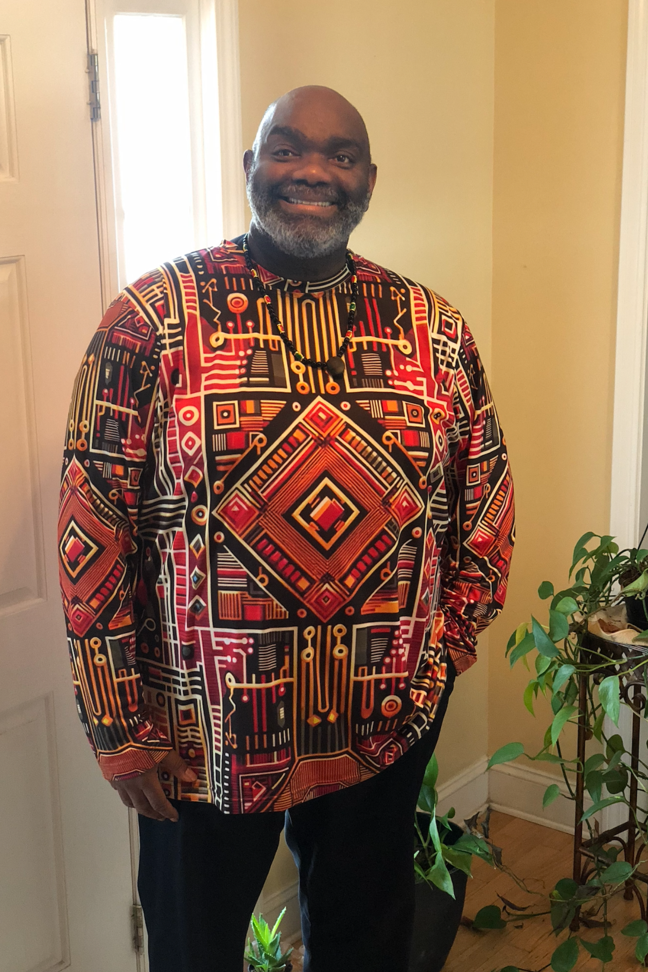 Black Male Wearing a Black History Month Afrofuturism Kente Cloth Design in Alicia McCalla's Storefront